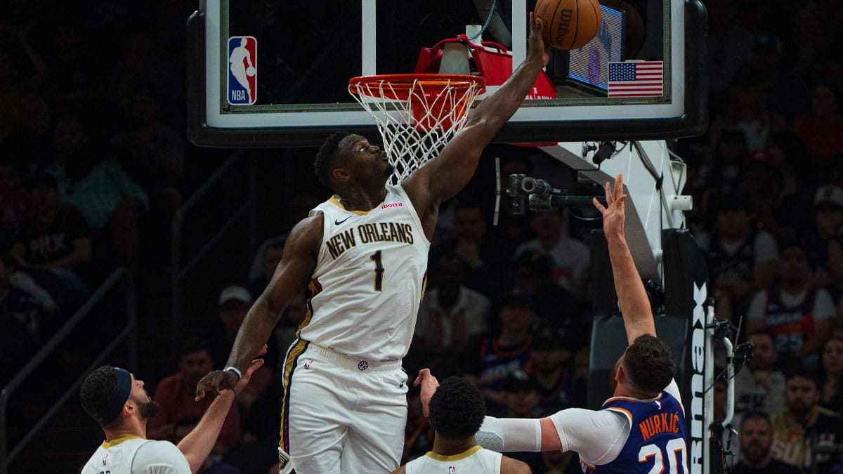 New Orleans Pelicans forward Zion Williamson (1) blocks the shot of Phoenix Suns center Jusuf Nurkic (20) during the first half at Footprint Center.