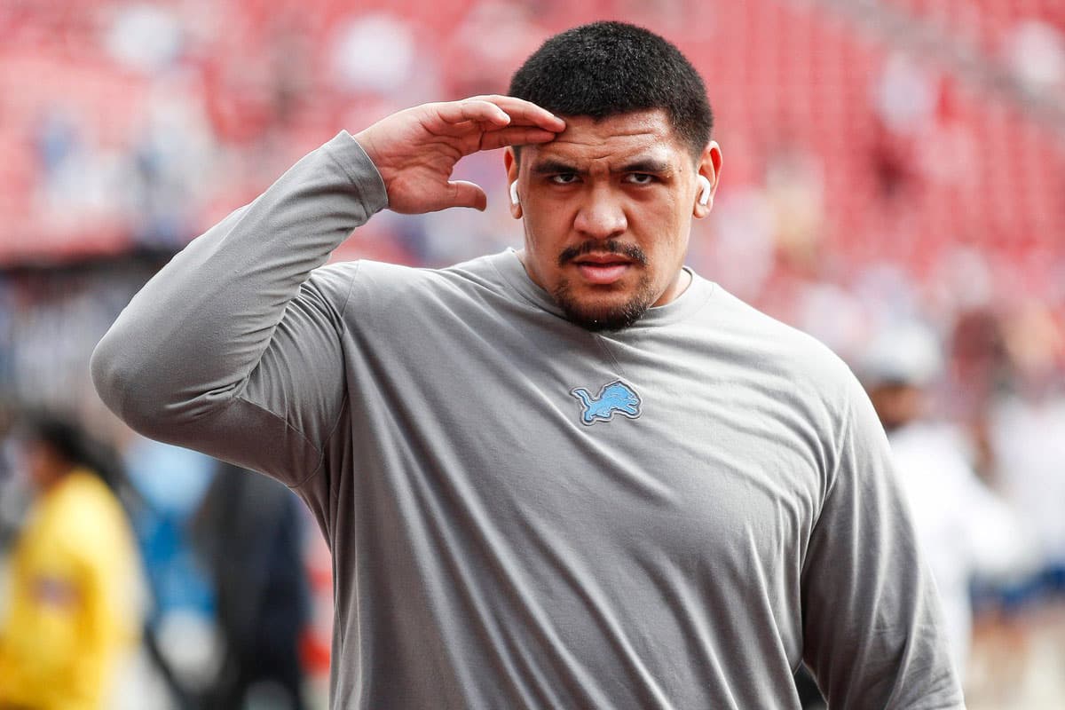 Detroit Lions offensive tackle Penei Sewell salutes fans during warms up before the NFC championship game against San Francisco 49ers at Levi's Stadium in Santa Clara