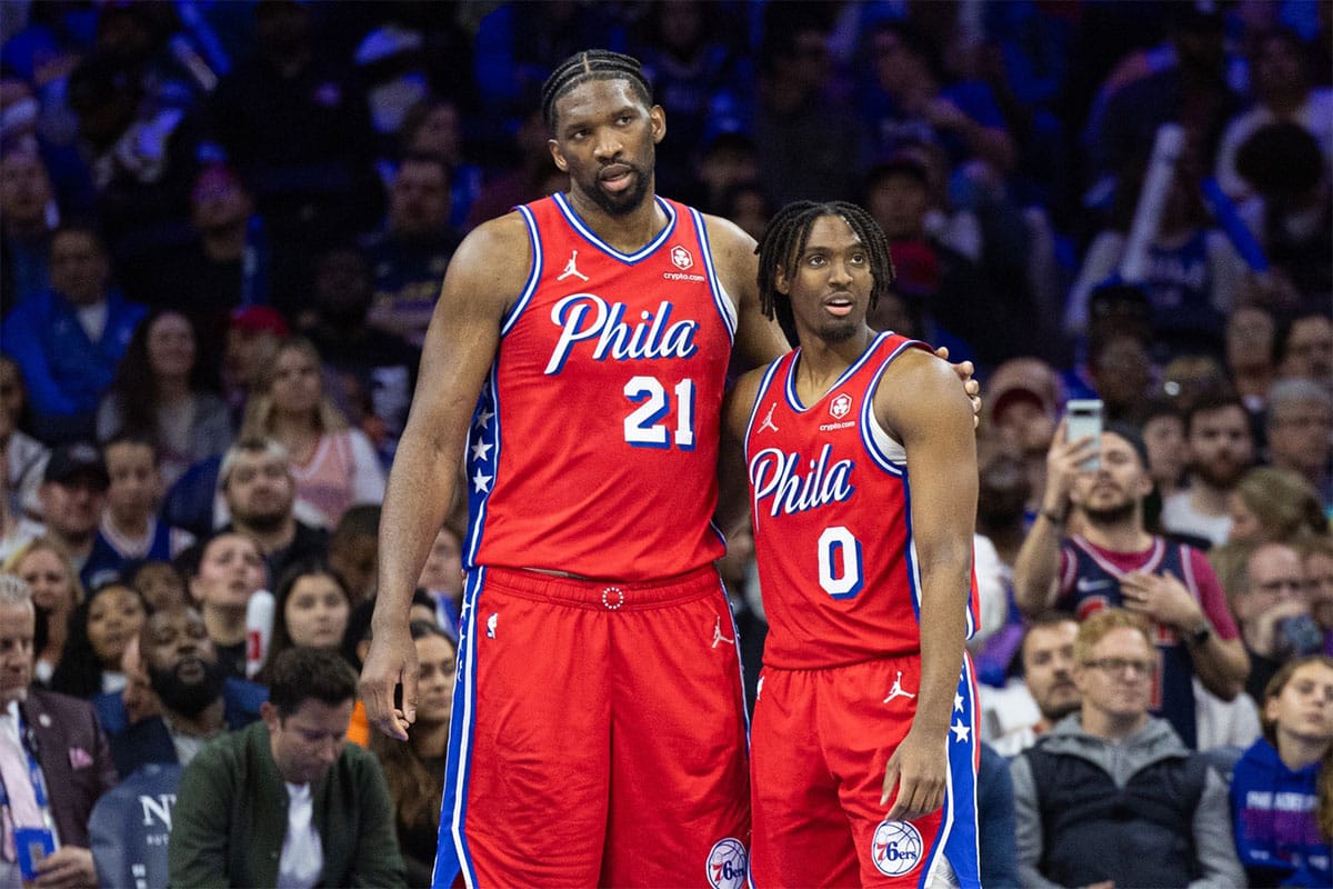 Philadelphia 76ers center Joel Embiid (21) and guard Tyrese Maxey (0) stand together during a break in action in the fourth quarter against the Orlando Magic at Wells Fargo Center. 