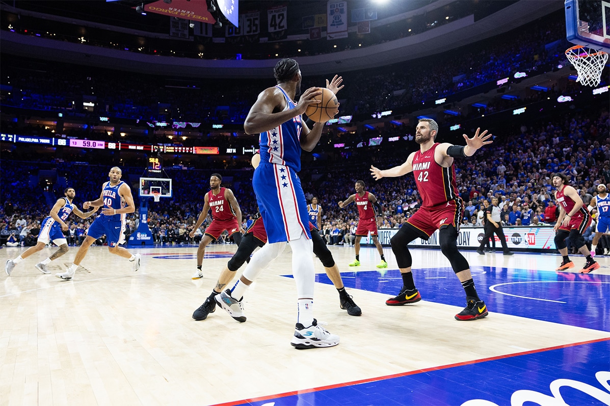 Philadelphia 76ers center Joel Embiid (21) controls the ball agains the defense of the Miami Heat during the third quarter of a play-in game of the 2024 NBA playoffs at Wells Fargo Center.
