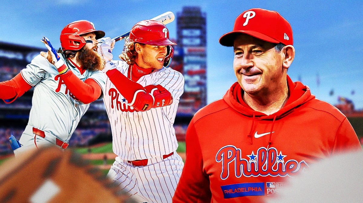 Phillies manager Rob Thomson next to Alec Bohm, Brandon Marsh
