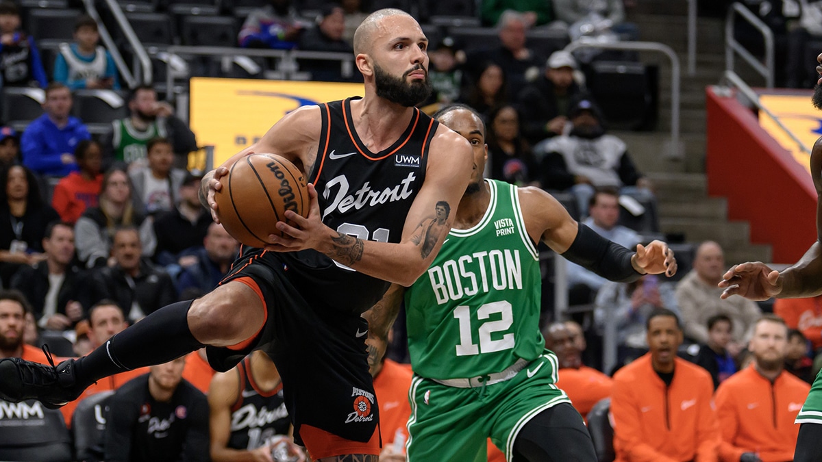Detroit Pistons guard Evan Fournier (31) looks to pass under the basket while being guarded by Boston Celtics forward Oshae Brissett (12) in the first quarter at Little Caesars Arena