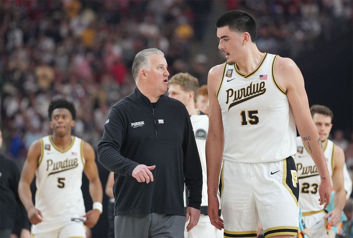 Purdue Boilermakers head coach Matt Painter talks with Purdue Boilermakers center Zach Edey (15) at halftime against the North Carolina State Wolfpack in the semifinals of the men's Final Four of the 2024 NCAA Tournament at State Farm Stadium
