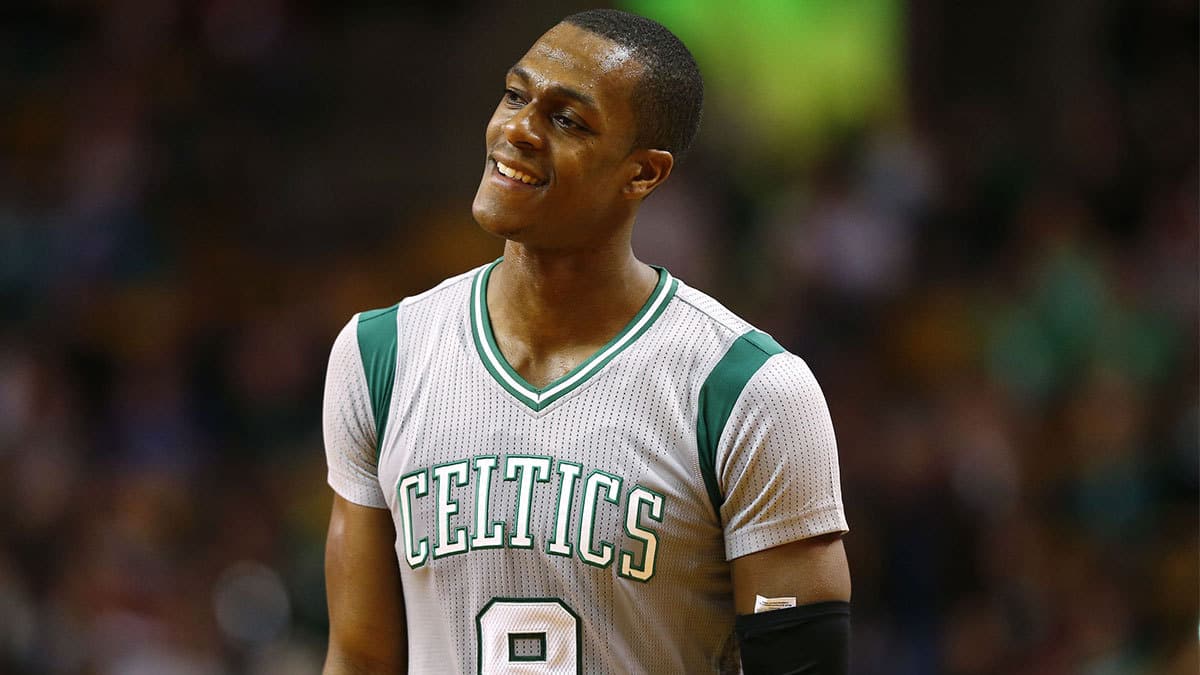 Rajon Rondo (9) smiles after being pushed out of a Washington Wizards huddle during the second half of the Boston Celtics 101-93 win over the Washington Wizards at TD Garden. 