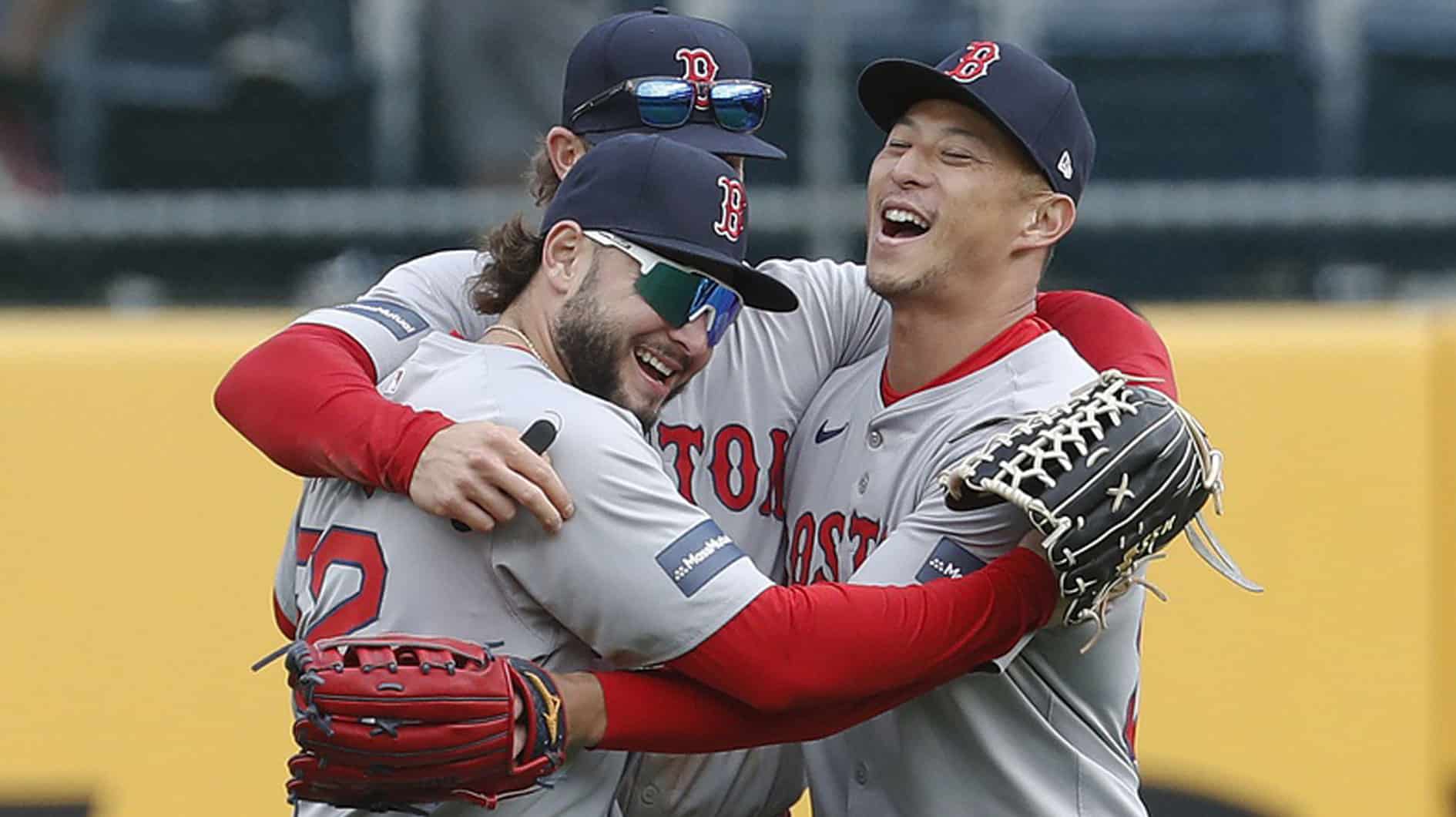 Boston Red Sox left fielder Wilyer Abreu (52) and center fielder Jarren Duran (middle) and right fielder Rob Refsnyder (right) celebrate in the outfield after defeating the Pittsburgh Pirates at PNC Park. Boston won 6-1