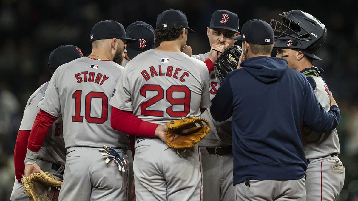 Boston Red Sox, from left, shortstop Trevor Story (10), third baseman Bobby Dalbec (29), relief pitcher Josh Winckowski (25), pitching coach Andrew Bailey and catcher Reese McGuire (3) meet at the mound during the eighth inning against the Seattle Mariners and at T-Mobile Park.