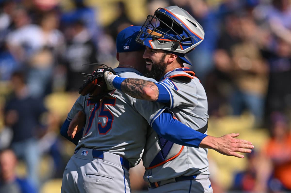 New York Mets pitcher Reed Garrett (75) and catcher Omar Narvaez (2) react after defeating the Los Angeles Dodgers during the ninth inning at Dodger Stadium.
