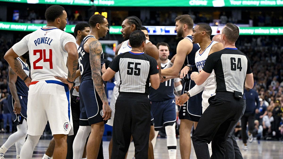 The NBA referees separate Dallas Mavericks forward P.J. Washington (25) and LA Clippers guard Russell Westbrook (0) as they exchange words during the fourth quarter during game three of the first round for the 2024 NBA playoffs at the American Airlines Center