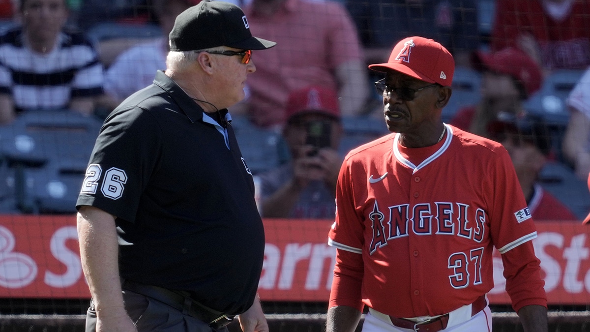 Ron Washington of the Angels speaks with umpire Bill Miller. 
