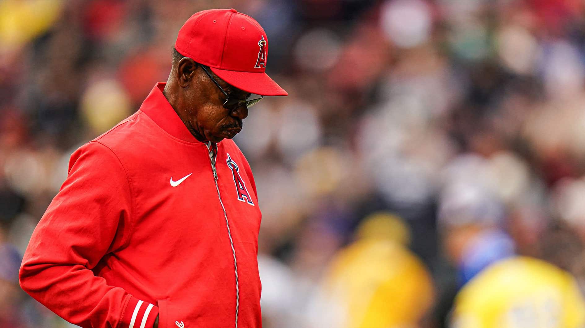Los Angeles Angels manager Ron Washington (37) makes his way back to the dugout after talking with his players from the pitching mound as they take on the Boston Red Sox in the eighth inning at Fenway Park.