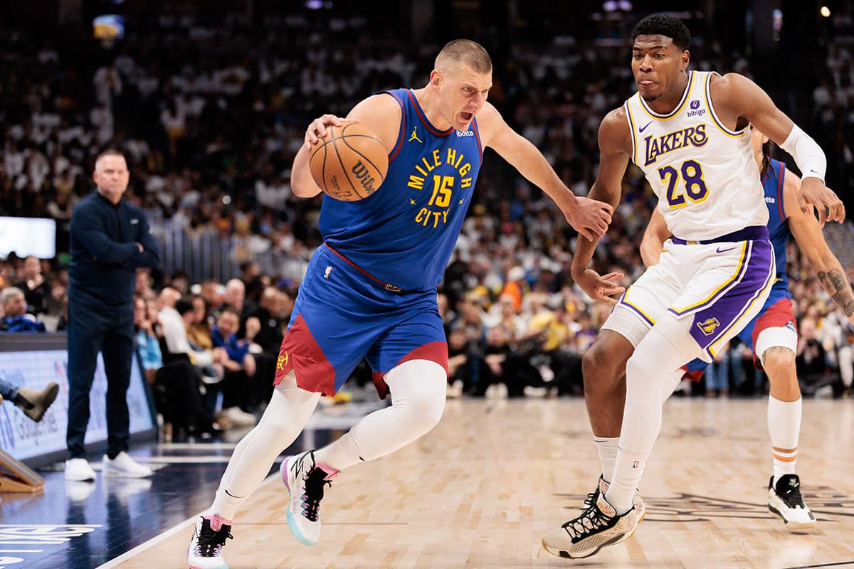 Denver Nuggets center Nikola Jokic (15) drives to the basket against Los Angeles Lakers forward Rui Hachimura (28) during the first quarter in game one of the first round for the 2024 NBA playoffs at Ball Arena.
