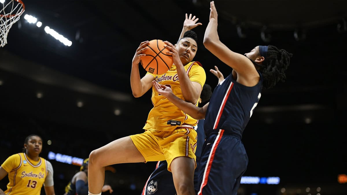 USC Trojans guard JuJu Watkins (12) is fouled by UConn Huskies forward Aaliyah Edwards (3) during the second half in the finals of the Portland Regional of the NCAA Tournament 