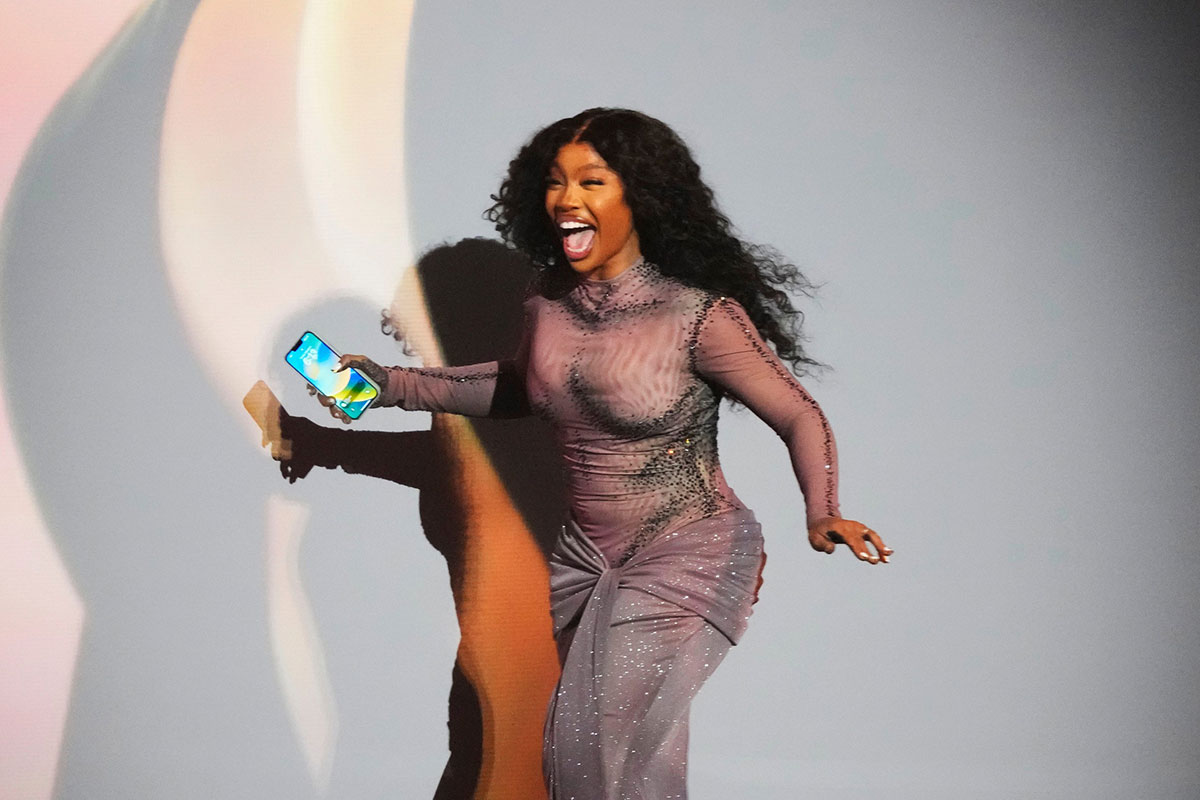 SZA runs to accept her Grammy award for best R&B Song