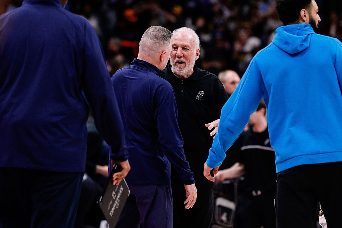 Denver Nuggets head coach Michael Malone (L) and San Antonio Spurs head coach Gregg Popovich (R) after the game at Ball Arena.