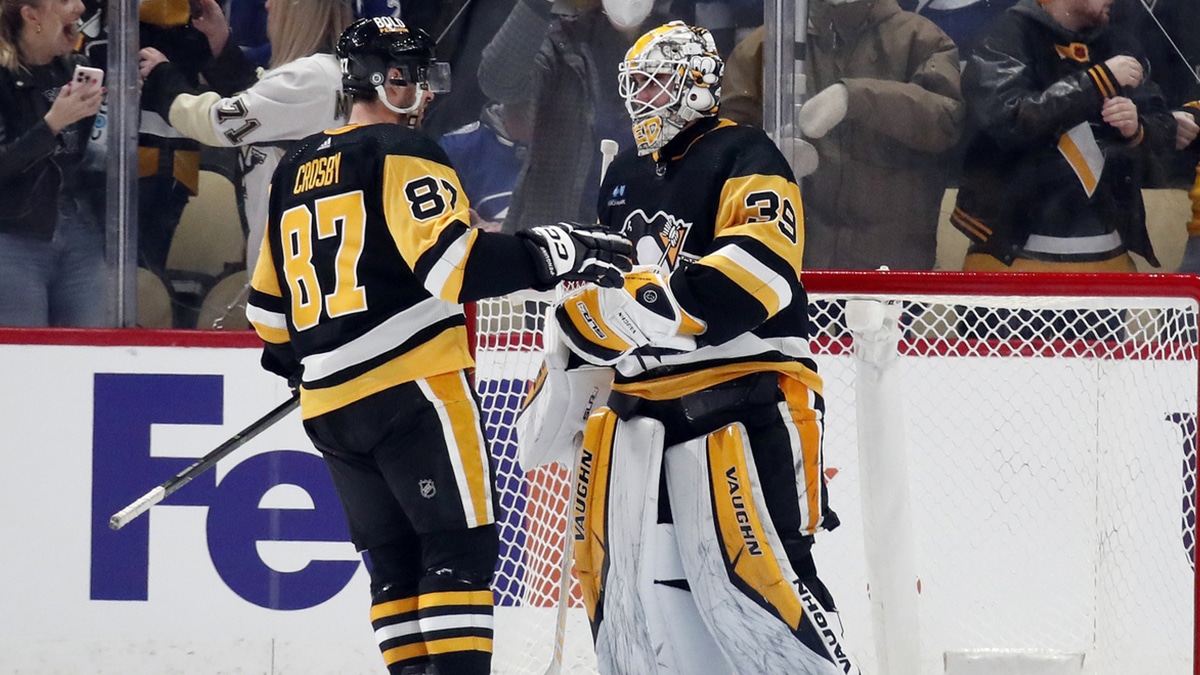 Pittsburgh Penguins center Sidney Crosby (87) and goaltender Alex Nedeljkovic (39) celebrate after defeating the Tampa Bay Lightning at PPG Paints Arena. The Penguins won 5-4.