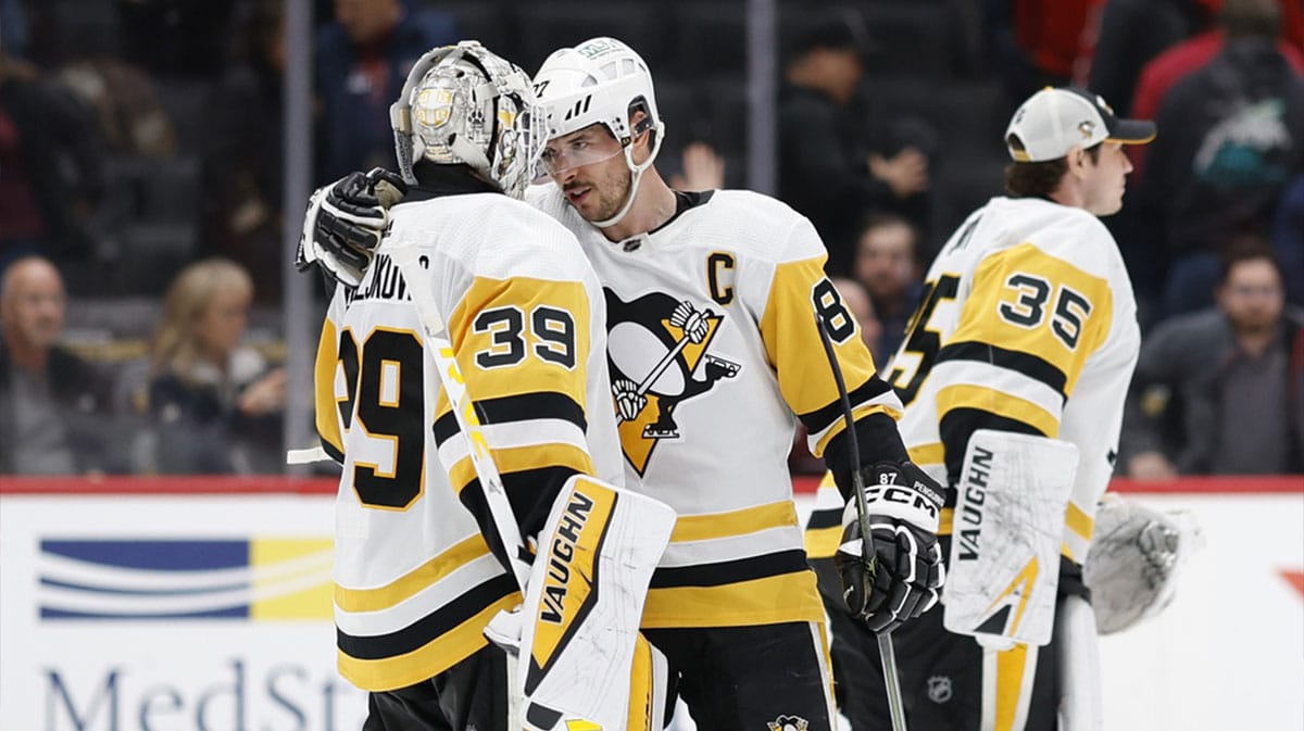 Pittsburgh Penguins center Sidney Crosby (87) celebrates with Penguins goaltender Alex Nedeljkovic (39) after their game against the Washington Capitals at Capital One Arena