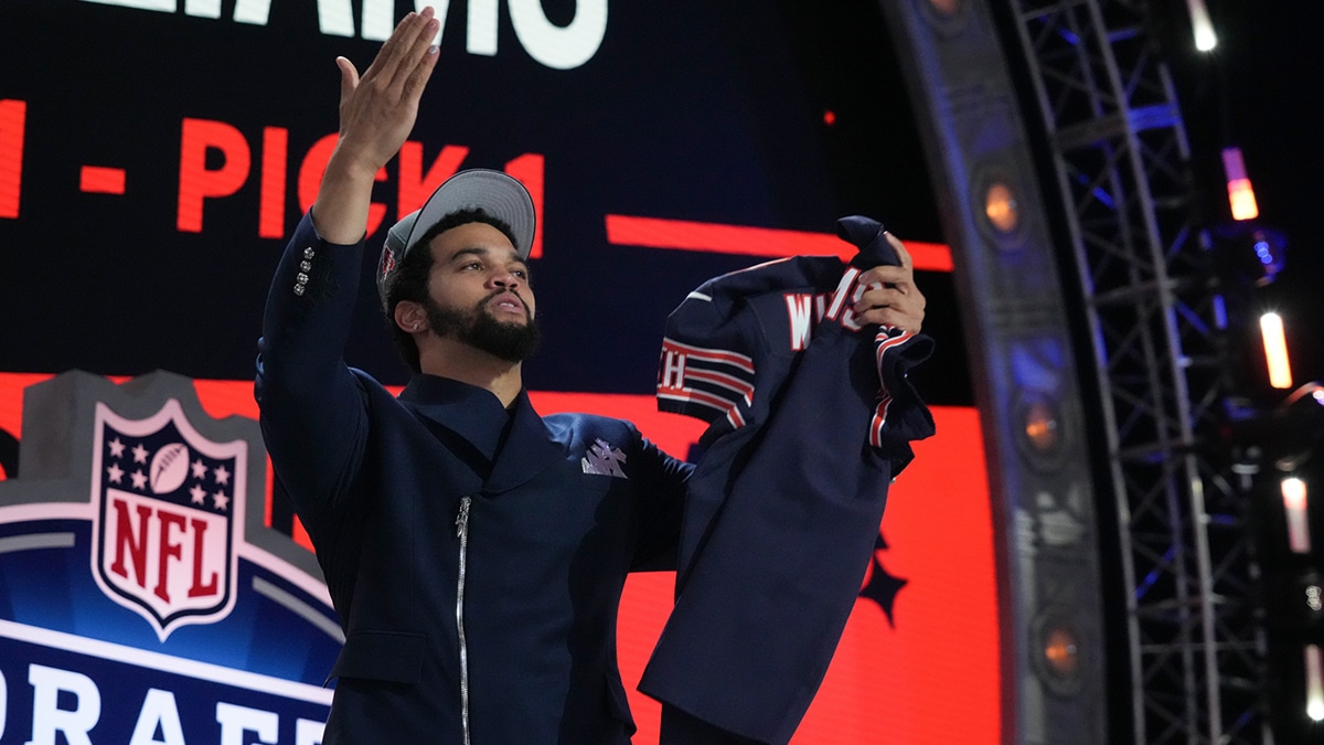 Southern California Trojans quarterback Caleb Williams holds up his jersey after being selected by the Chicago Bears as the No. 1 pick in the first round of the 2024 NFL Draft at Campus Martius Park and Hart Plaza.