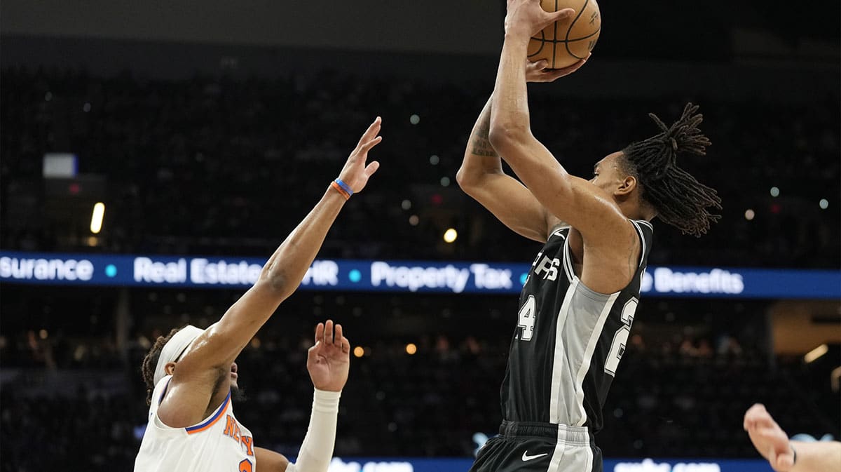 San Antonio Spurs guard Devin Vassell (24) shoots over New York Knicks guard Miles McBride (2) during the first half at Frost Bank Center.