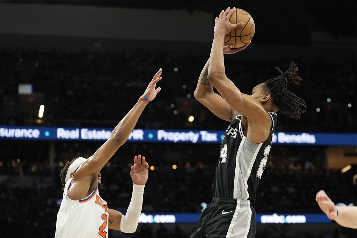  San Antonio Spurs guard Devin Vassell (24) shoots over New York Knicks guard Miles McBride (2) during the first half at Frost Bank Center.
