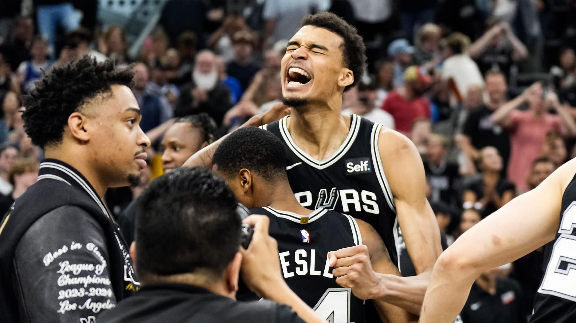 San Antonio Spurs forward Victor Wembanyama (1) and teammates react after a victory over the Denver Nuggets at Frost Bank Center.