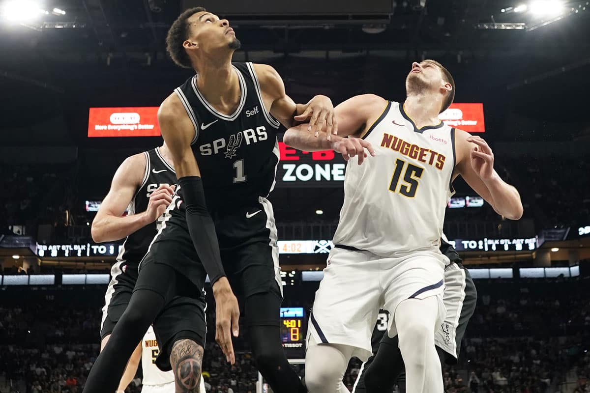 Denver Nuggets center Nikola Jokic (15) and San Antonio Spurs forward Victor Wembanyama (1) box out for a rebound during the second half at Frost Bank Center. 