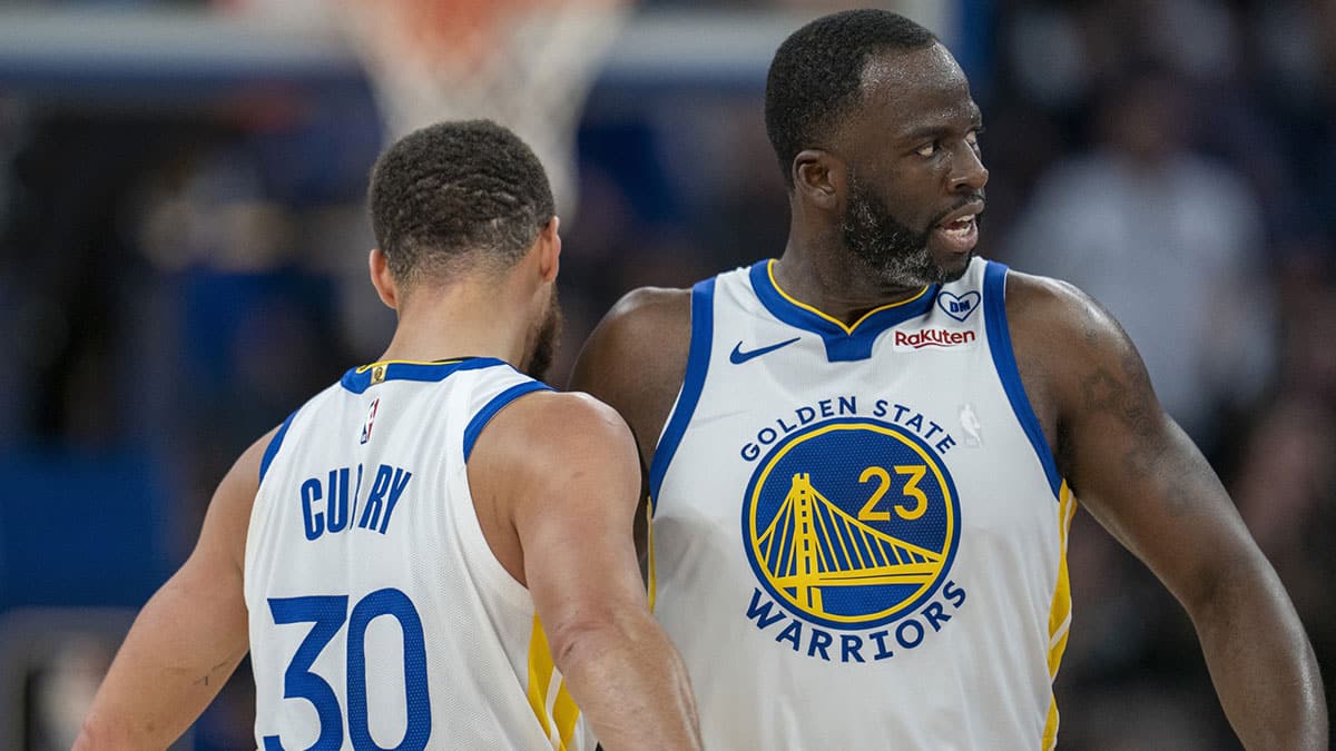 Golden State Warriors guard Stephen Curry (30) and forward Draymond Green (23) celebrate after the three point basket against the Philadelphia 76ers during the third quarter at Chase Center.