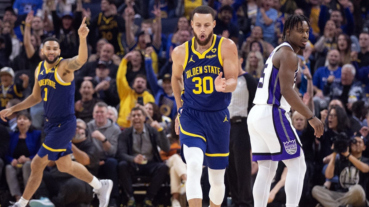 Golden State Warriors guard Stephen Curry (30) celebrates a 3-point basket in front of Sacramento Kings guard Davion Mitchell (15) during the first quarter at Chase Center. 
