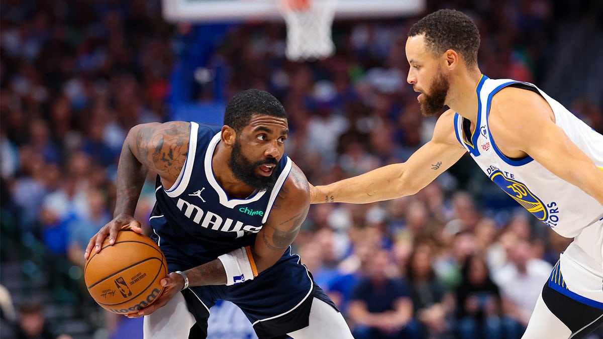Dallas Mavericks guard Kyrie Irving (11) looks to score as Golden State Warriors guard Stephen Curry (30) defends during the first half at American Airlines Center.