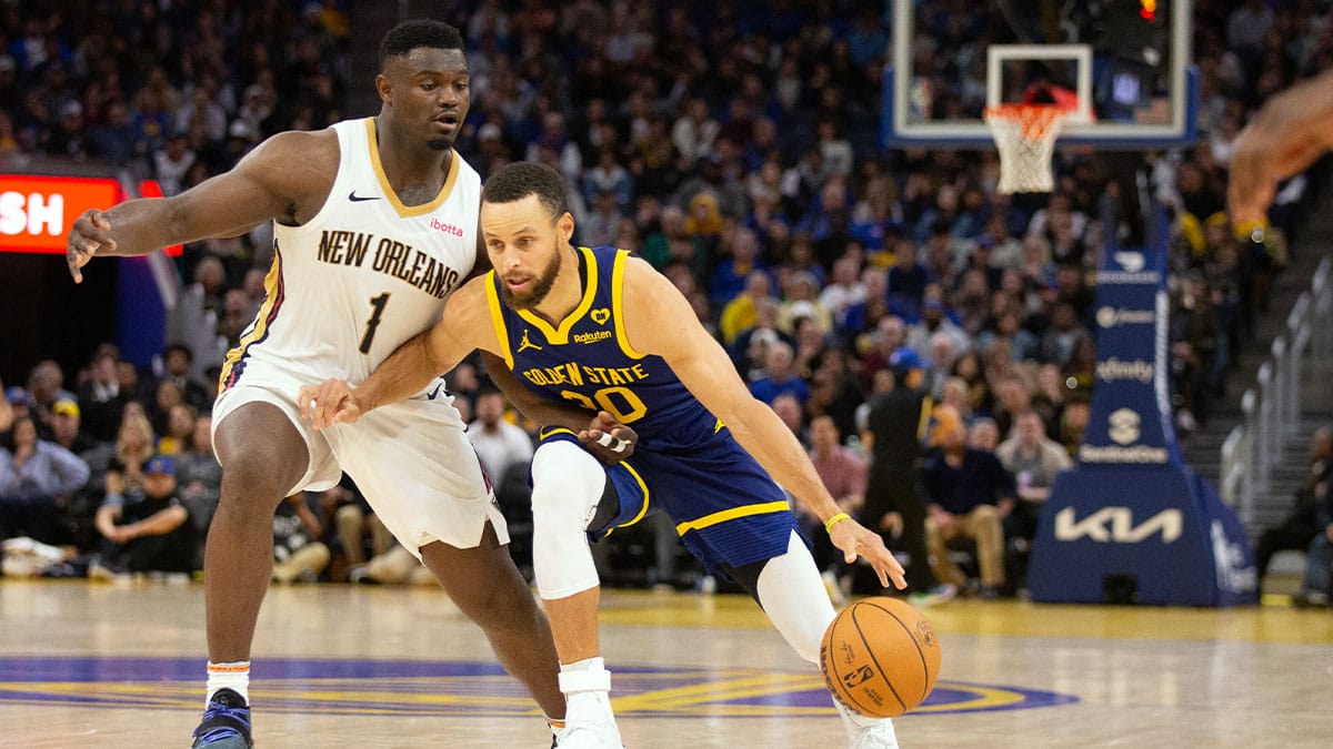 Golden State Warriors guard Stephen Curry (30) dribbles around New Orleans Pelicans forward Zion Williamson (1) during the fourth quarter at Chase Center