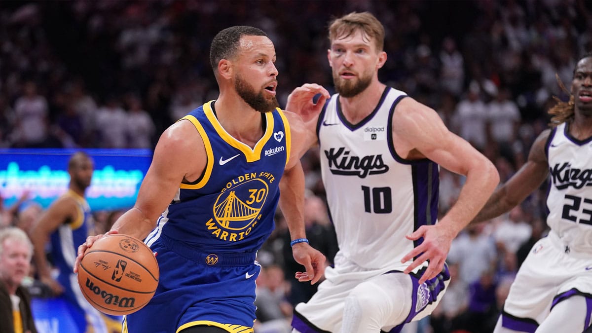 Golden State Warriors guard Stephen Curry (30) dribbles the ball in front of Sacramento Kings forward Domantas Sabonis (10) in the fourth quarter during a play-in game of the 2024 NBA playoffs at the Golden 1 Center.
