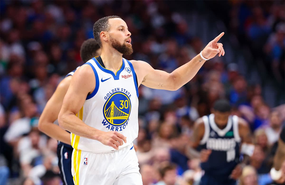 Golden State Warriors guard Stephen Curry (30) reacts after scoring during the first half against the Dallas Mavericks at American Airlines Center.
