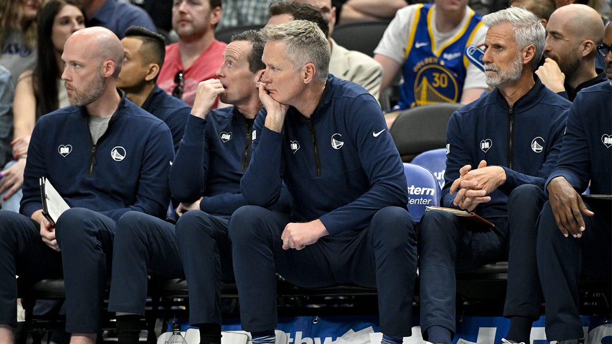Golden State Warriors head coach Steve Kerr (center) sits on the team bench during the second half between the Dallas Mavericks and the Warriors at the American Airlines Center. 