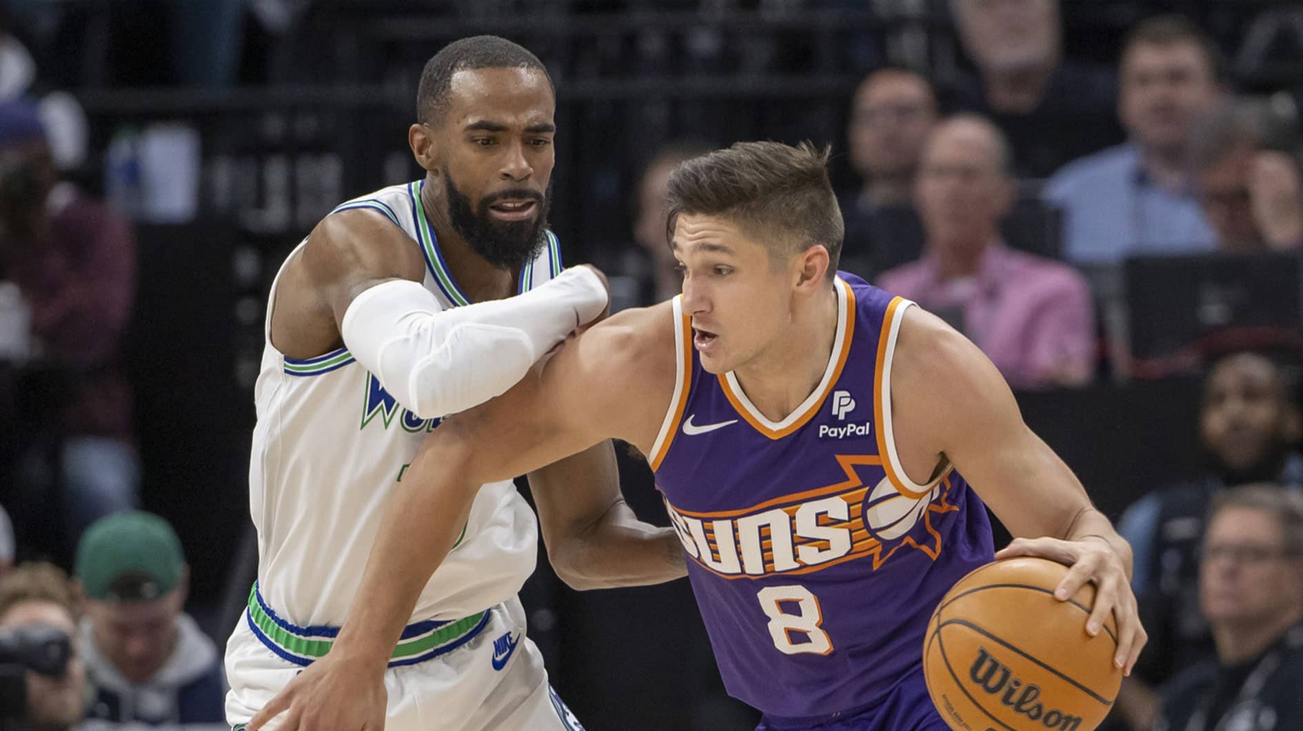 Phoenix Suns guard Grayson Allen (8) drives to the basket as Minnesota Timberwolves guard Mike Conley (10) plays defense in the second half during game one of the first round for the 2024 NBA playoffs at Target Center.