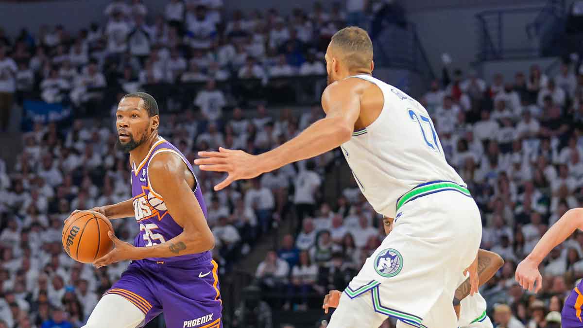 hoenix Suns forward Kevin Durant (35) dribbles against Minnesota Timberwolves center Rudy Gobert (27) in the second quarter during game two of the first round for the 2024 NBA playoffs at Target Center