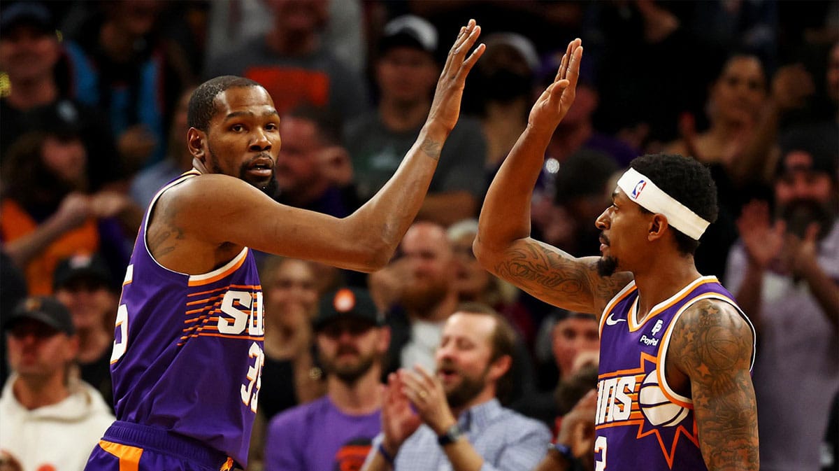 Phoenix Suns forward Kevin Durant (35) celebrates with guard Bradley Beal (3) during the first quarter of the game against the Oklahoma City Thunder at Footprint Center.
