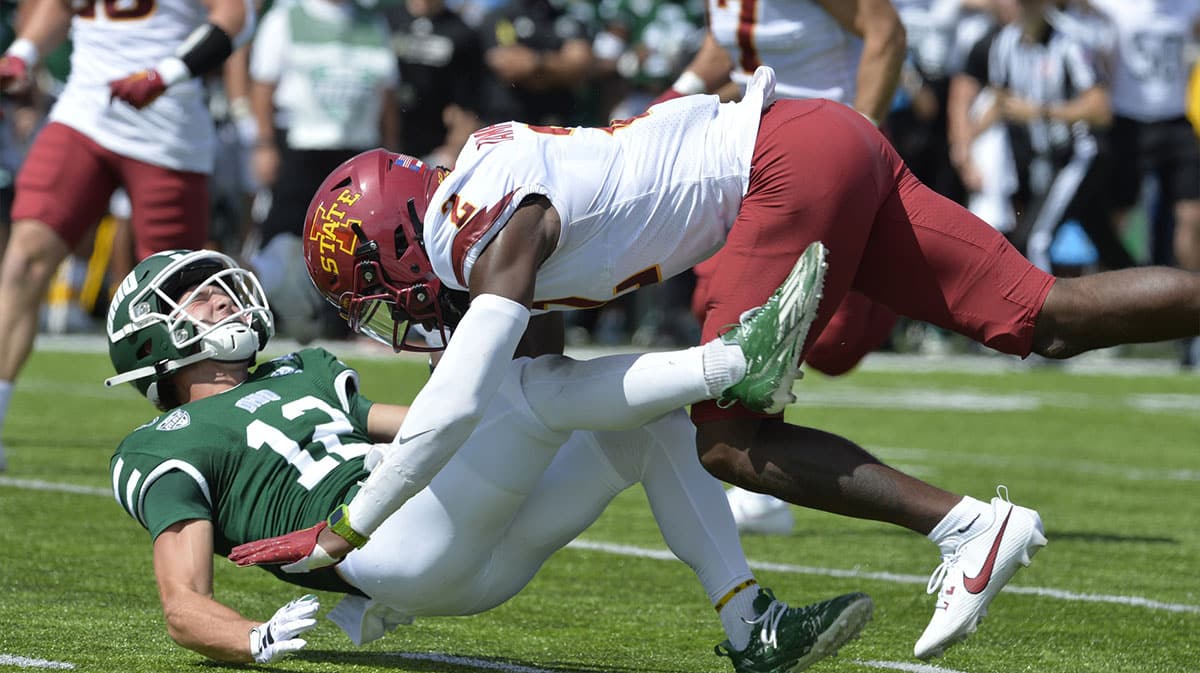 Ohio Bobcats wide receiver Sam Wiglusz (12) takes a hit from Iowa State Cyclones defensive back T.J. Tampa (2) during the second quarter at Peden Stadium