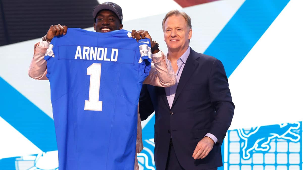 Terrion Arnold, a cornerback from the University of Alabama, shows off his Detroit Lions jersey with NFL commissioner Roger Goodell after he was picked in the first round of the 2024 NFL draft at the NFL draft theater in Detroit 