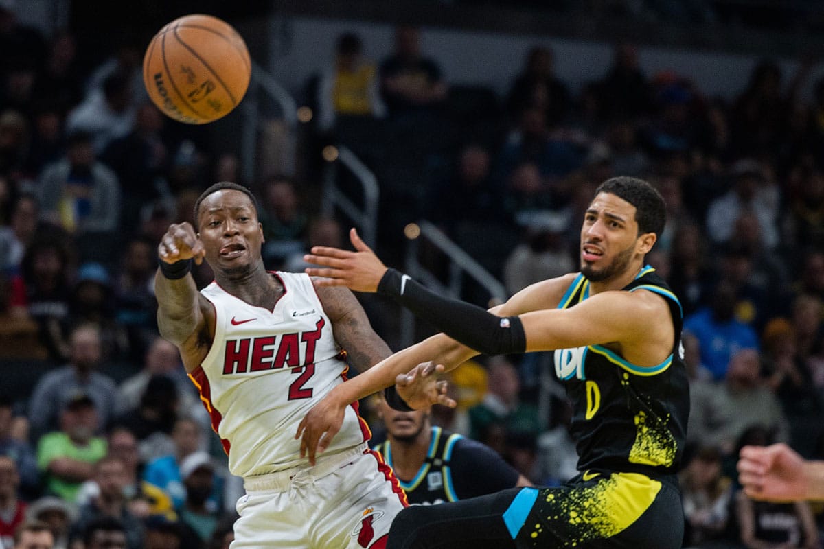 Miami Heat guard Terry Rozier (2) passes the ball while Indiana Pacers guard Tyrese Haliburton (0) defends in the second half at Gainbridge Fieldhouse.