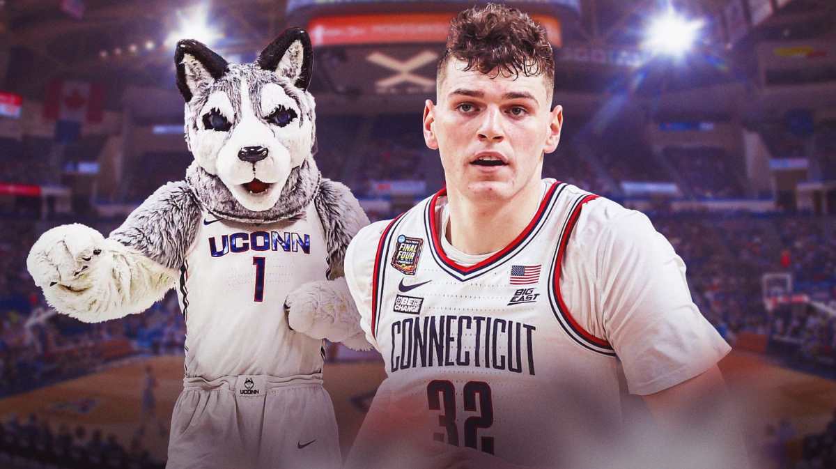 Donovan Clingan (UConn basketball) looking serious with UConn Huskies mascot in the background