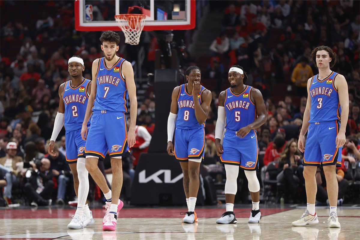 Oklahoma City Thunder guard Shai Gilgeous-Alexander (2), forward Chet Holmgren (7), forward Jalen Williams (8), guard Luguentz Dort (5) and guard Josh Giddey (3) walk on the court during the second half of a basketball game against the Chicago Bulls at United Center