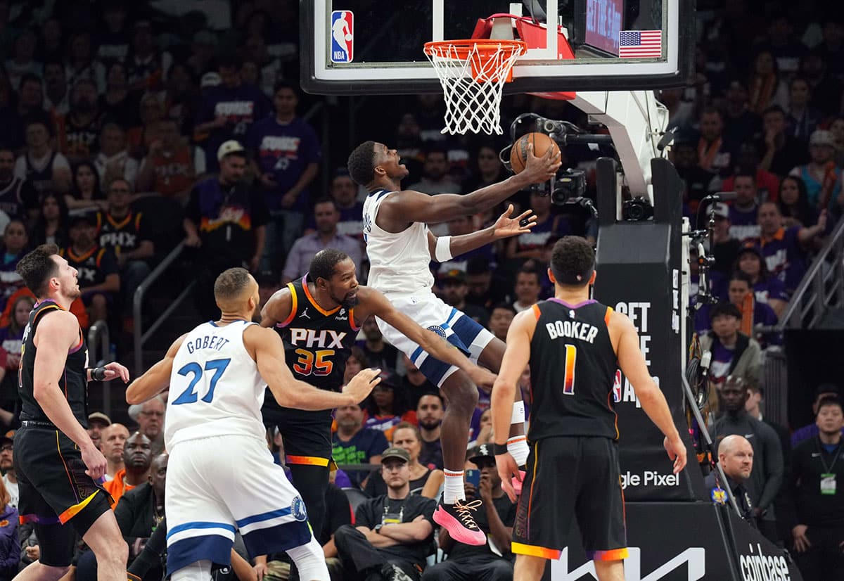 Minnesota Timberwolves guard Anthony Edwards (5) puts up a layup against the Phoenix Suns during the second half of game three of the first round for the 2024 NBA playoffs at Footprint Center.
