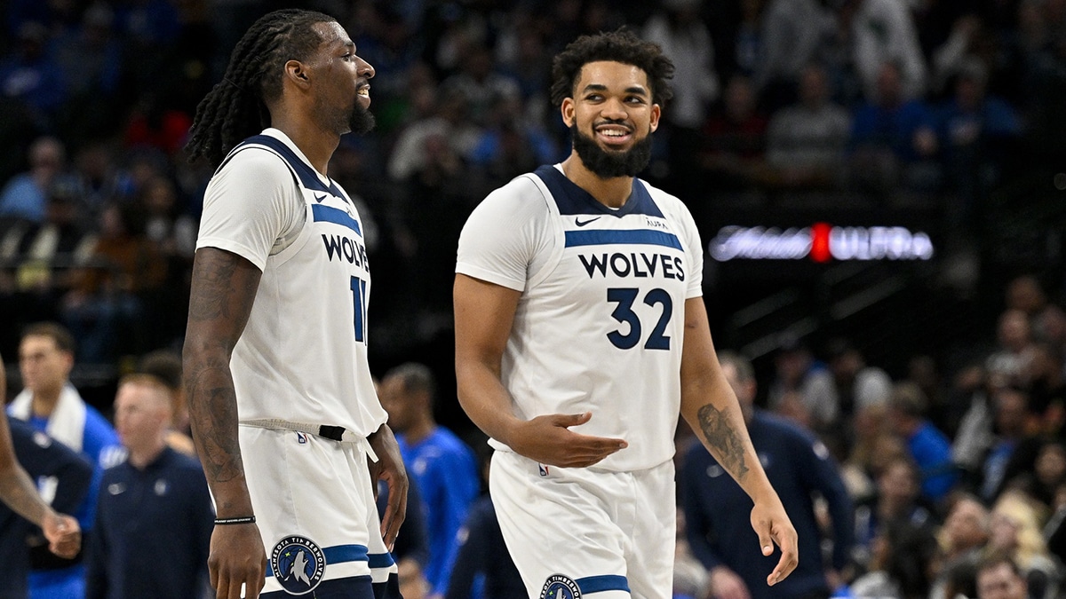 Minnesota Timberwolves center Naz Reid (11) and center Karl-Anthony Towns (32) walk off the court during the second half against the Dallas Mavericks at the American Airlines Center