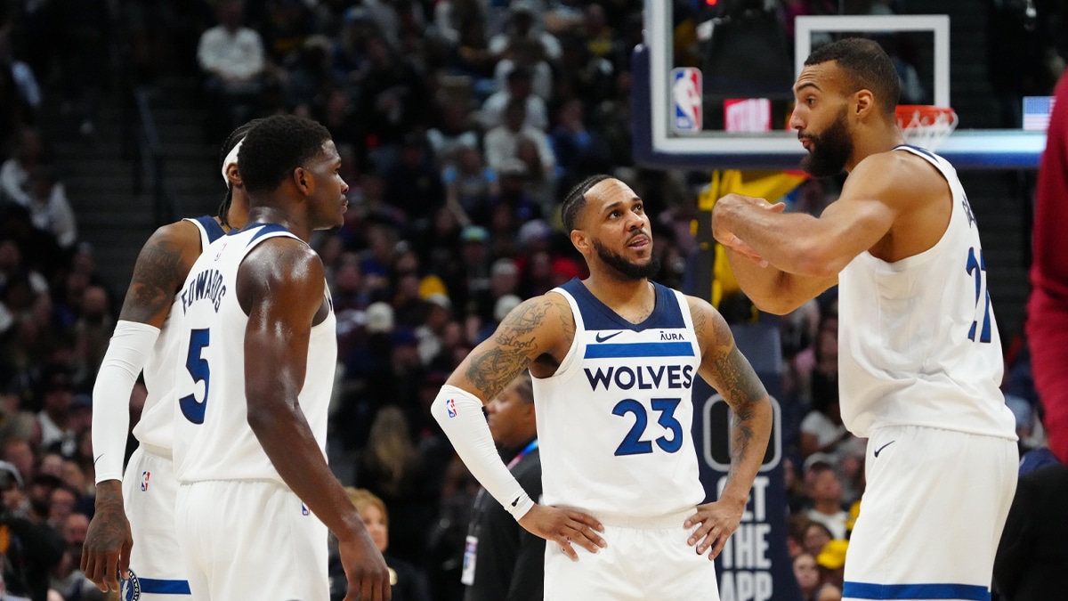 Minnesota Timberwolves center Rudy Gobert (27) and guard Monte Morris (23) and guard Anthony Edwards (5) and forward Jaden McDaniels (3) huddle in the second half against the Denver Nuggets at Ball Arena