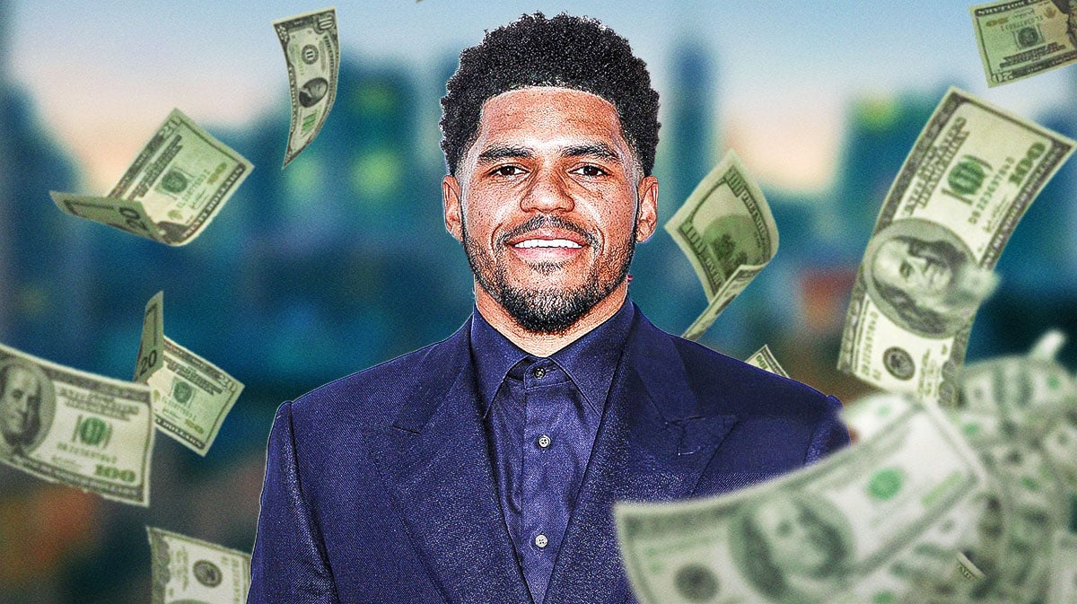 Tobias Harris surrounded by piles of cash.
