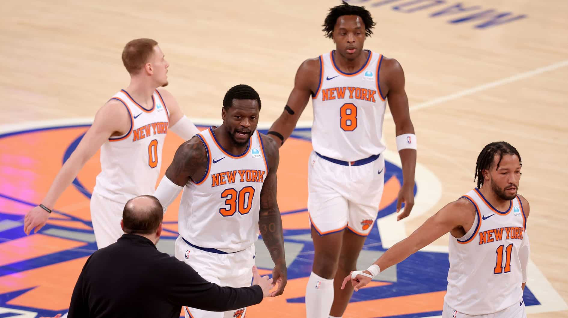 New York Knicks head coach Tom Thibodeau high fives New York Knicks forward Julius Randle (30) with guard Donte DiVincenzo (0) and forward OG Anunoby (8) and guard Jalen Brunson (11) during the first quarter against the Washington Wizards at Madison Square Garden