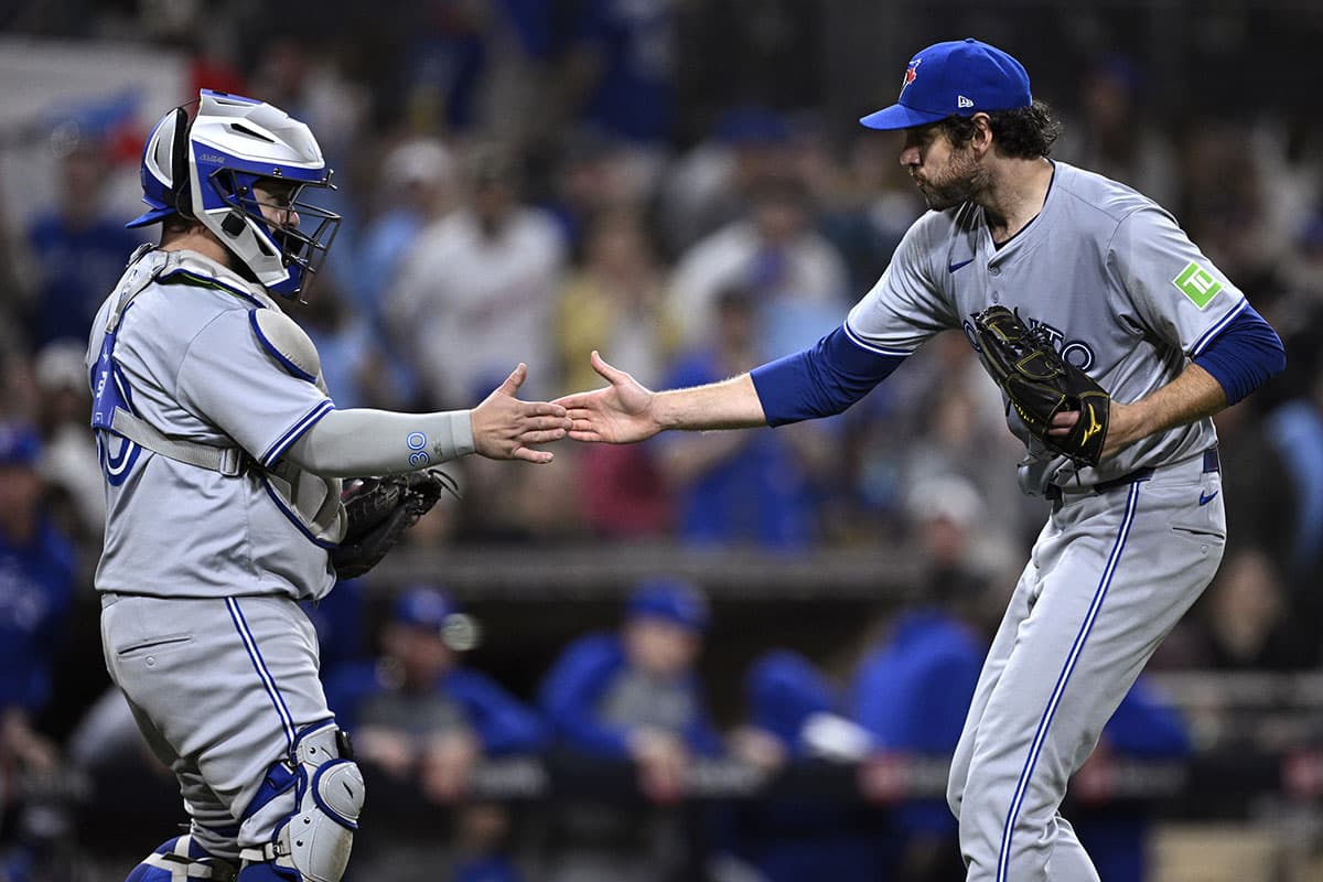 Toronto Blue Jays relief pitcher Jordan Romano (right) and catcher Alejandro Kirk (30) celebrate on the field after defeating the San Diego Padres at Petco Park. 