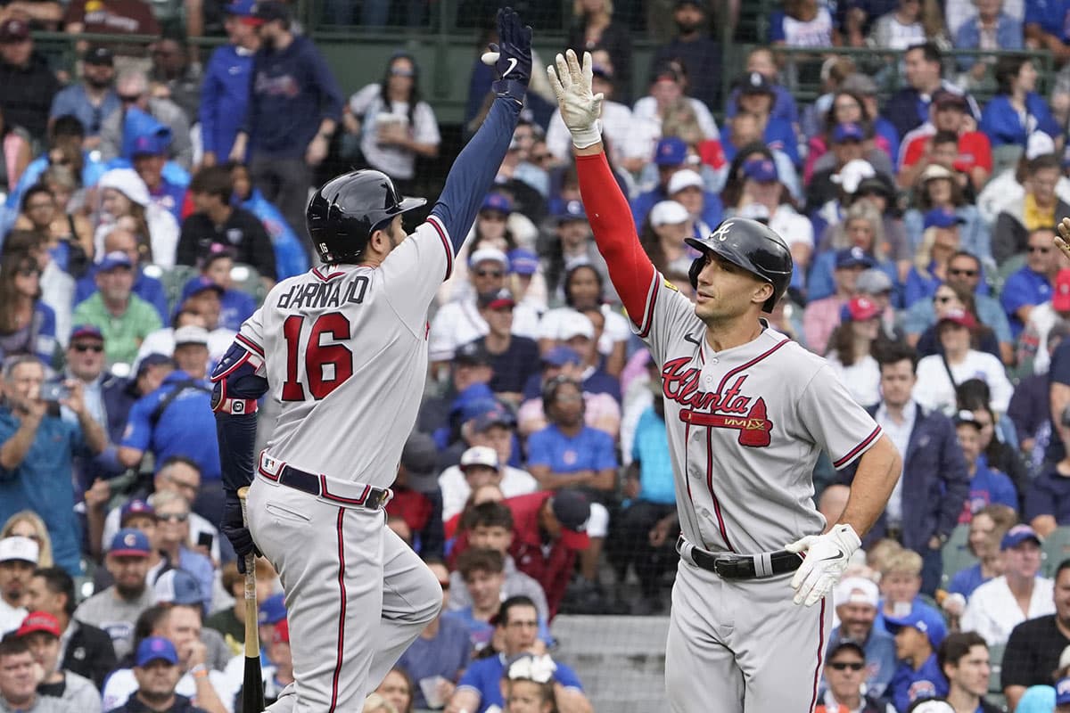 Atlanta Braves first baseman Matt Olson (28) is greeted by catcher Travis d'Arnaud (16) after hitting a two-run home run against the Chicago Cubs during the third inning at Wrigley Field.