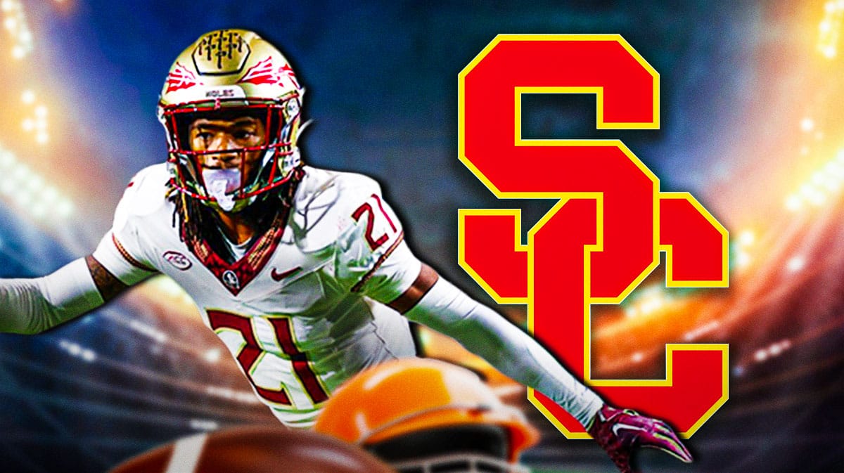 Former Florida State defense DB Greedy Vance Jr. stands next to USC logo, transfer portal reporters in bacgkround