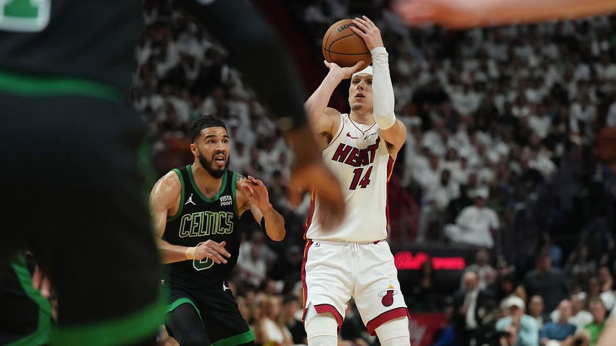 Miami Heat guard Tyler Herro (14) shoots as Boston Celtics forward Jayson Tatum (0) defends in the first half during game three of the first round for the 2024 NBA playoffs at Kaseya Center.