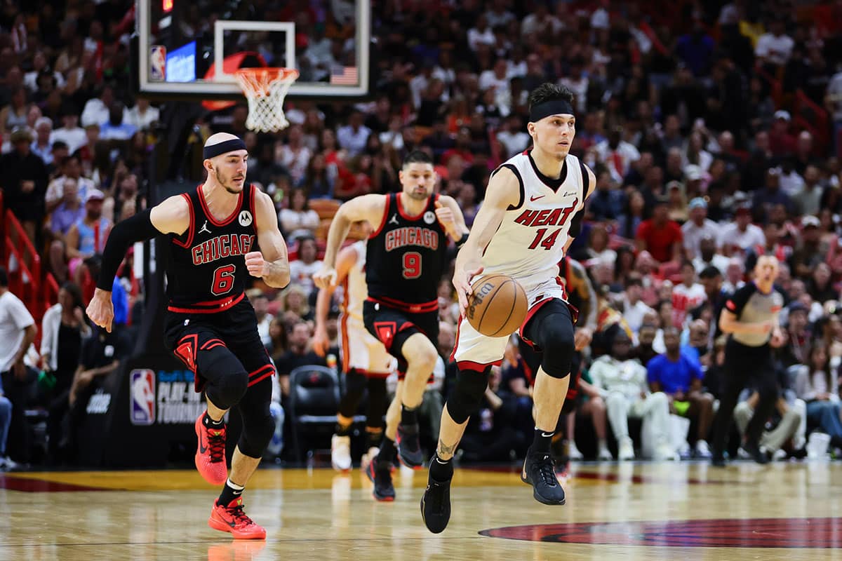  Miami Heat guard Tyler Herro (14) dribbles the basketball against the Chicago Bulls in the fourth quarter during a play-in game of the 2024 NBA playoffs at Kaseya Center.